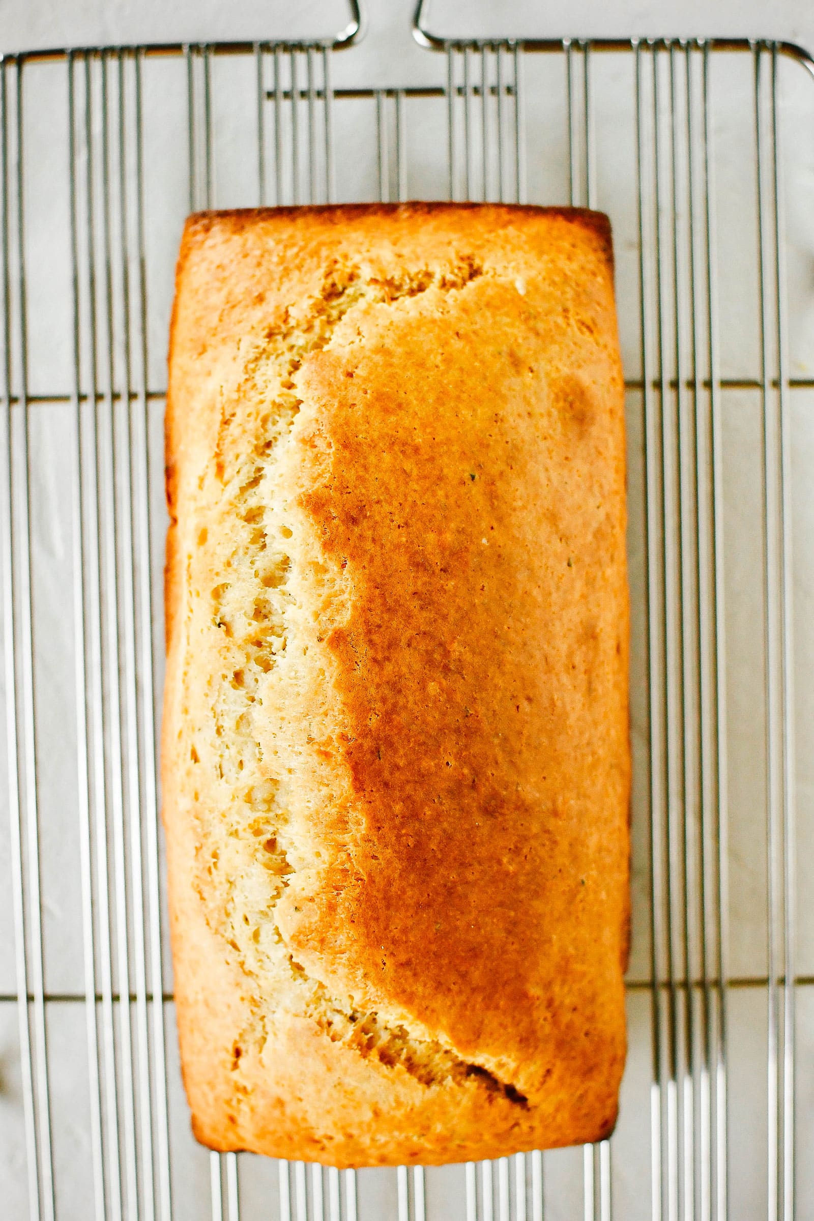 Grapefruit-rosemary loaf on a cooling rack