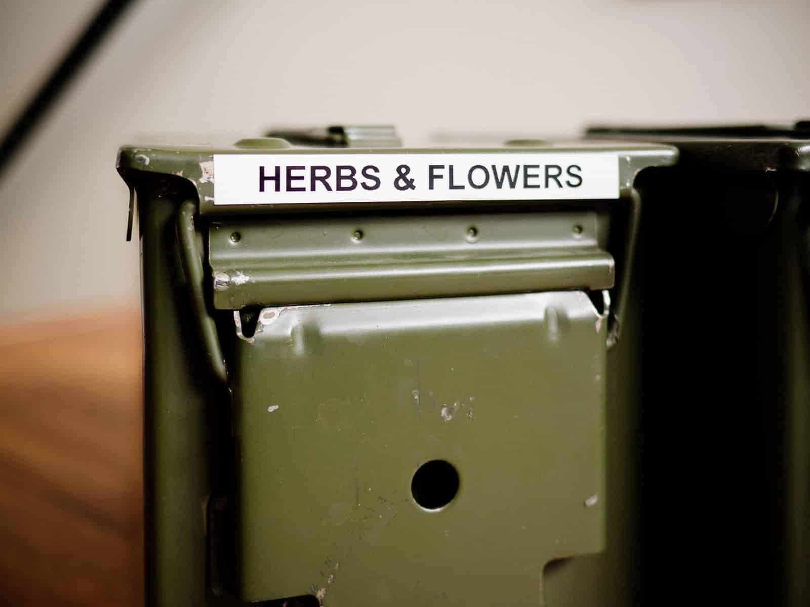 Metal ammo cans sitting on shelves in a workbench