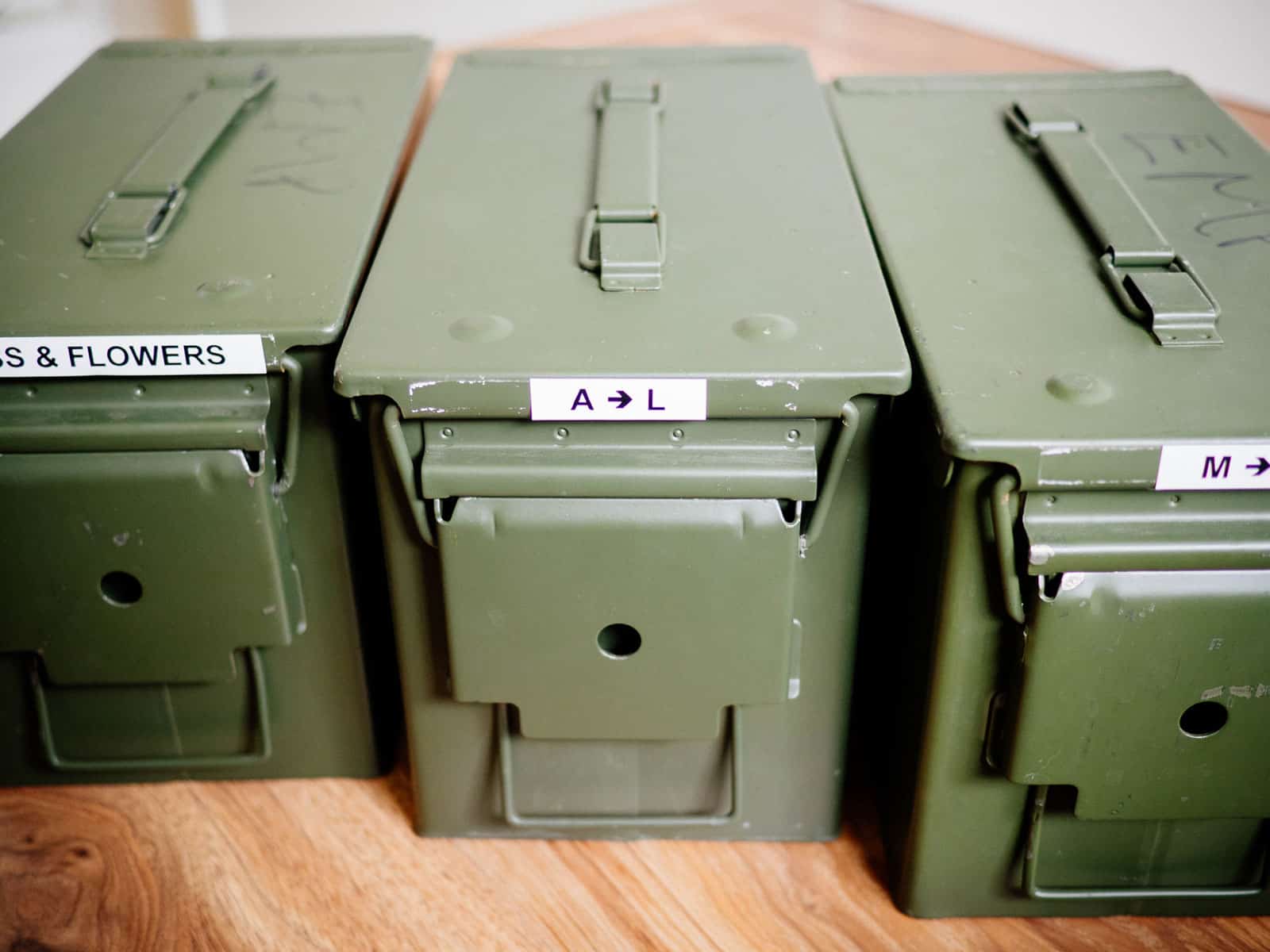Three green metal ammo cans used as seed packet storage
